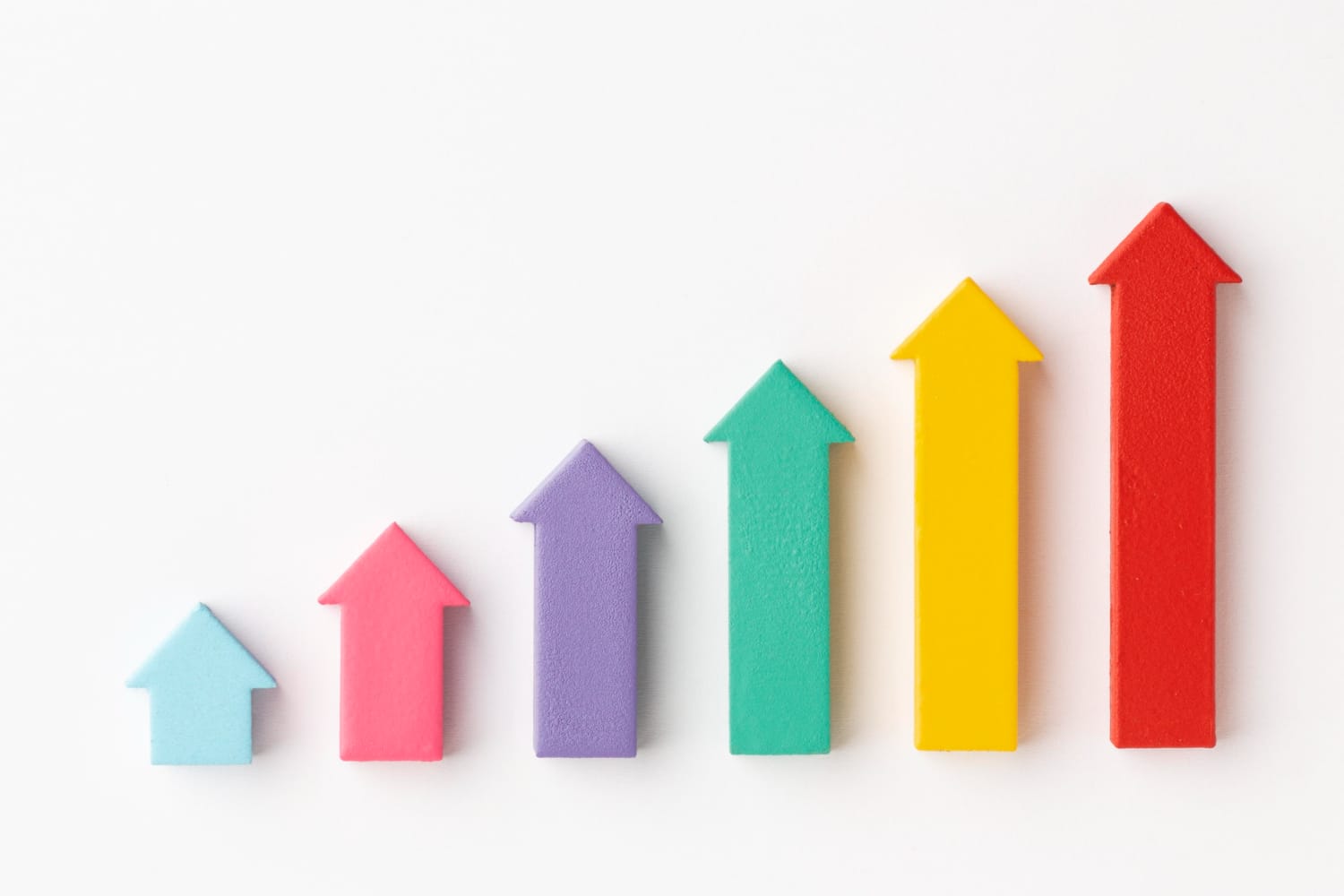 Six colorful arrows pointing upward, arranged in increasing height from left to right, symbolizing growth or progress within the Apple Ecosystem, on a white background.