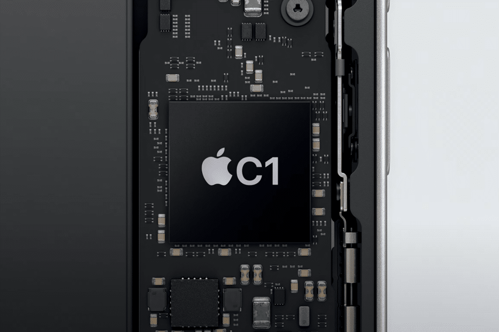 Close-up of an electronic circuit board inside a device, featuring a large black Apple C1 Modem chip at the center, labeled with "C1," and surrounded by various smaller components and connectors.