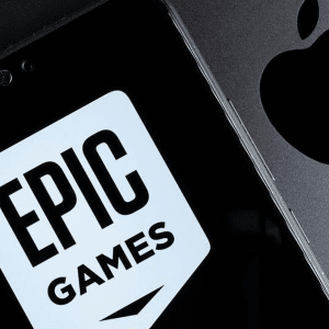 A smartphone displaying the Epic Games logo sits next to a device featuring the Apple logo, highlighting the epic rivalry between the two companies.