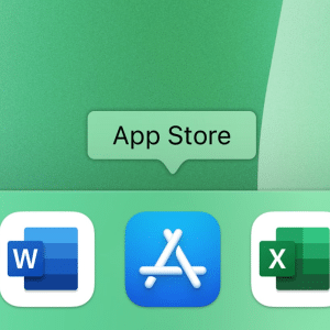 A close-up of a computer dock displays app icons like Microsoft Word, App Store, and Excel. A green label above the App Store icon clearly identifies it as “App Store.”.