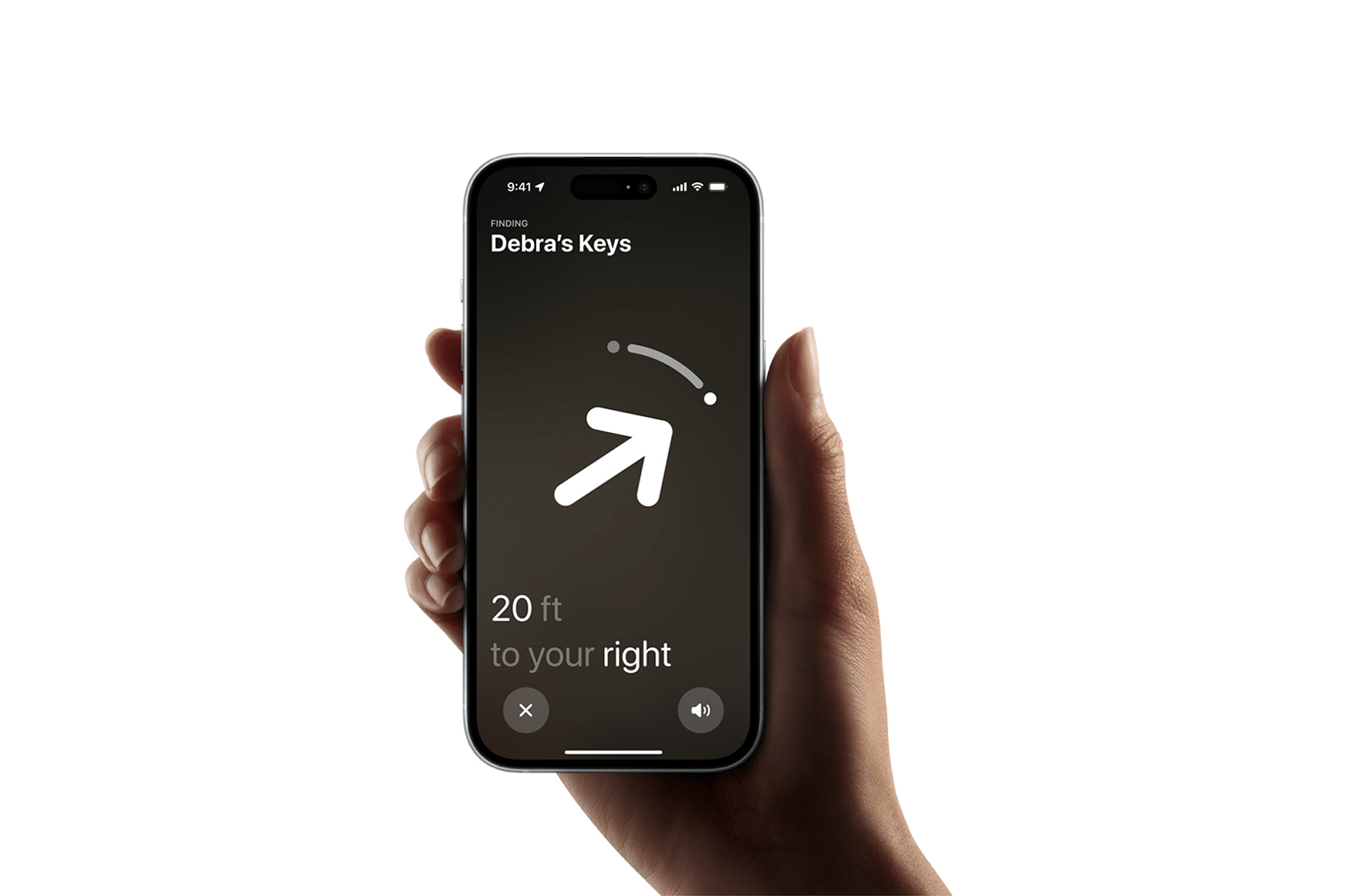 A hand holds a smartphone displaying an app with enhanced tracking that shows an arrow pointing to the right and text reading "20 ft to your right" under "Debra's Keys," indicating directions to a set of keys.