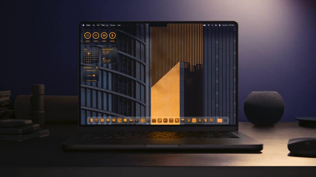A laptop on a dark desk displays a modern desktop with orange and gray widgets and icons, featuring weather, system info, and Apple Intelligence highlights, in front of a geometric building wallpaper. The background is dimly lit with a smart speaker nearby.