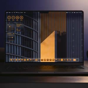 A laptop on a dark desk displays a modern desktop with orange and gray widgets and icons, featuring weather, system info, and Apple Intelligence highlights, in front of a geometric building wallpaper. The background is dimly lit with a smart speaker nearby.