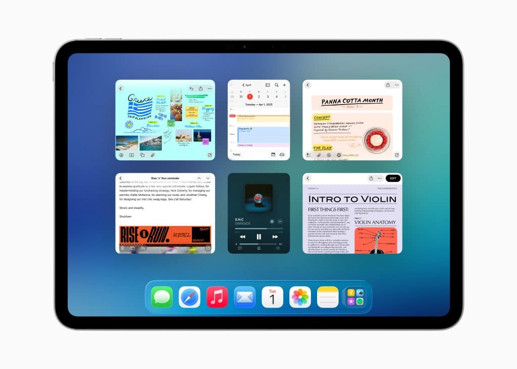 An iPad screen running iPadOS 26 displays six open app windows—notes, music, reminders, and web pages—in a multitasking view over a blue gradient background, with a dock of app icons at the bottom.