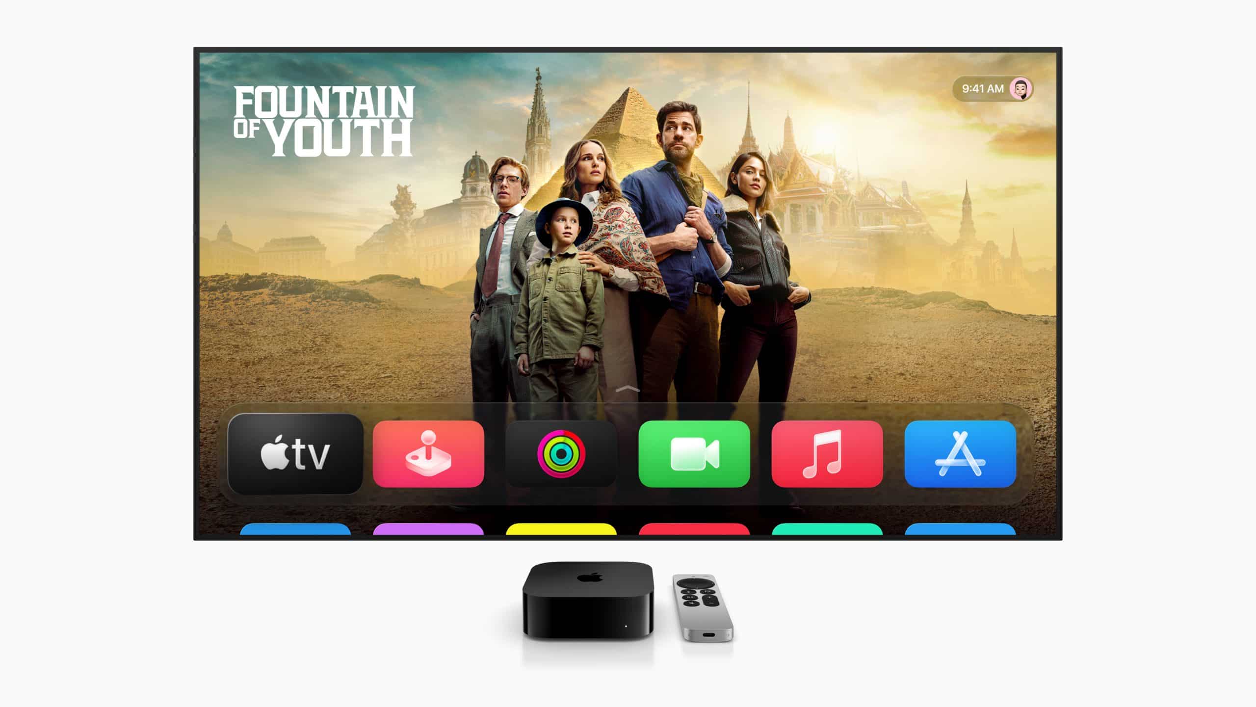 A TV screen running tvOS 26 displays a show titled “Fountain of Youth” with five people standing before ancient-style buildings. Below are colorful app icons, and an Apple TV device with a remote sits in front of the screen.