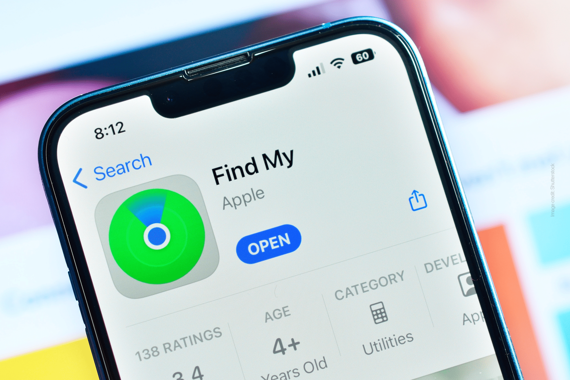Close-up of a smartphone screen displaying Find My on iPhone in the App Store, highlighting the app icon, "Open" button, ratings, age rating, and category details.
