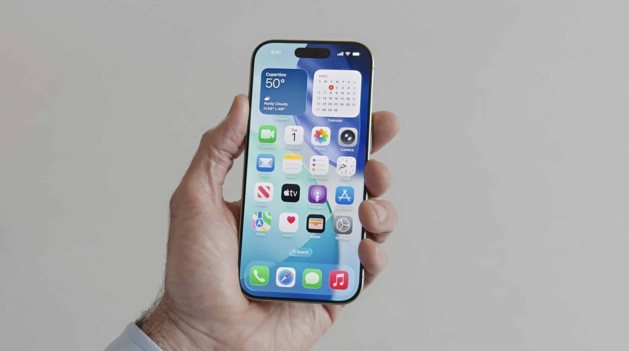 A hand holding an iPhone with a blue wallpaper showcases the Liquid Glass UI on the home screen, featuring various app icons and widgets like weather, calendar, messages, and maps against a neutral background.
