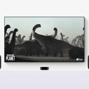 A TV screen with tvOS 26 displays a "Prehistoric Planet" scene on Apple TV+, showing large dinosaurs. Two AirPlay Speakers flank the TV, all set on a white surface—perfect for an immersive home theater experience.