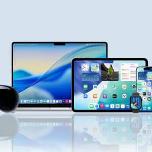 A group of Apple devices including a MacBook, iPad, iPhone, Apple Watch, Apple TV, and Apple Vision Pro headset displayed on a reflective surface with an Apple logo in the bottom right corner.