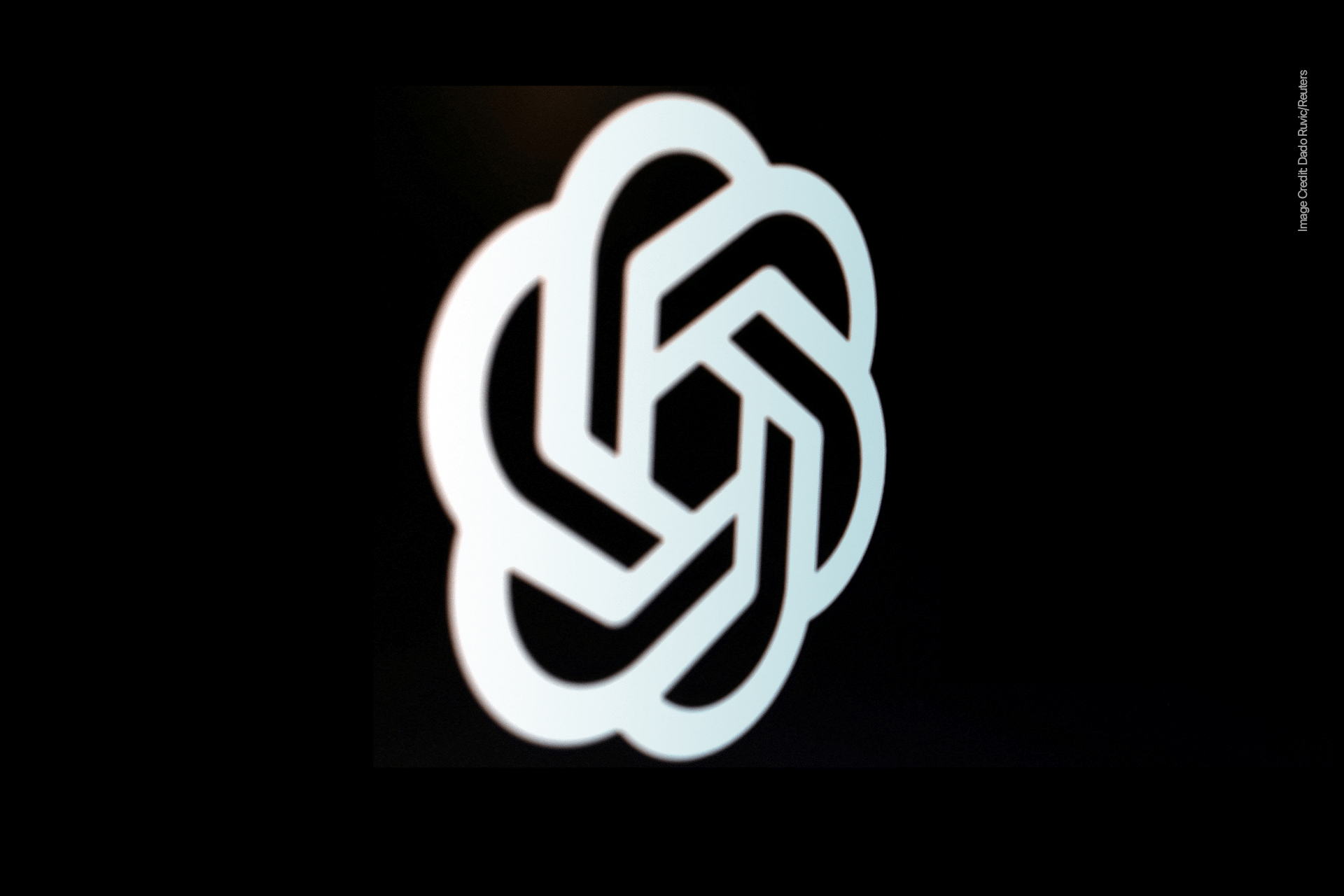 A white geometric, intertwined knot design on a black background, representing the OpenAI logo, symbolizes innovation behind ChatGPT and emerging models like GPT-5.