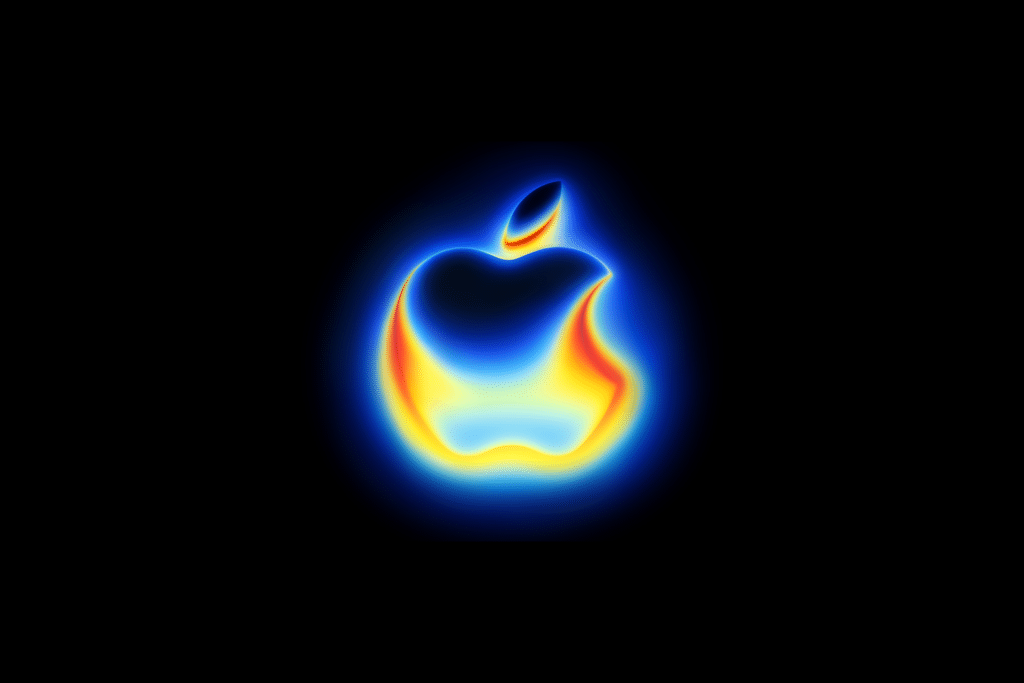 A glowing Apple logo shines with a vibrant gradient of blue, yellow, and red hues on a black background, creating a neon, heat-map effect reminiscent of the iconic style seen at an Apple September event.
