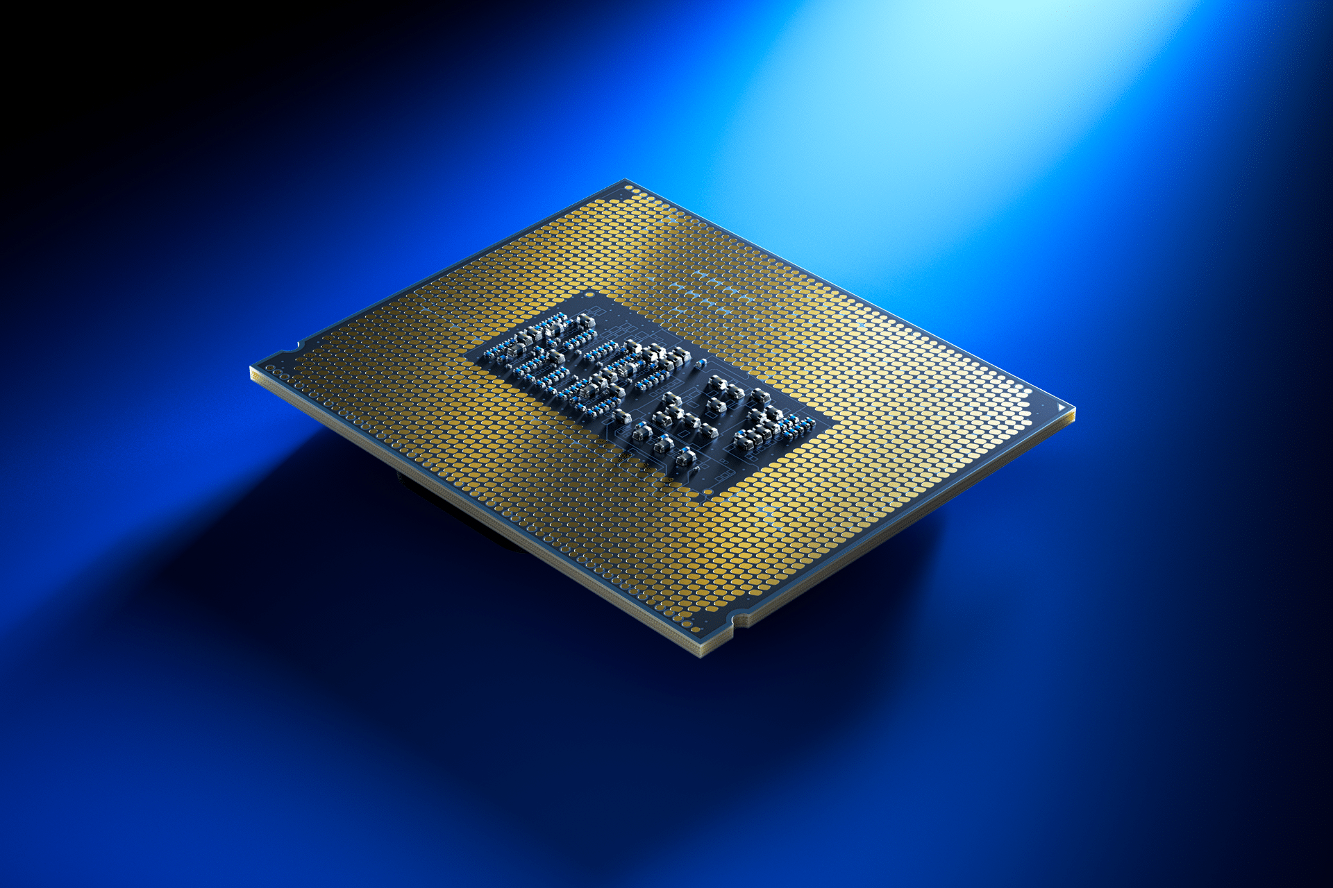 A computer processor chip with gold connectors, crafted by Intel, is shown against a blue background, illuminated by a spotlight from the upper right—highlighting advanced chip manufacturing coming to Ohio.