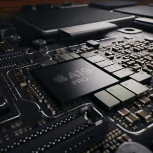Close-up of a computer motherboard featuring a central chip labeled "Apple A19 PRO," surrounded by various electronic components and circuitry.