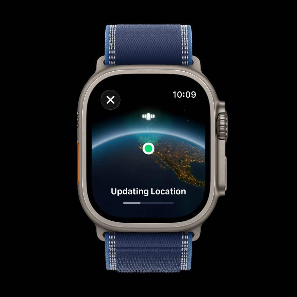A smartwatch with a blue strap displays a screen showing a globe with a green marker and the words "Updating Location" beneath it. The time on the watch is 10:09.