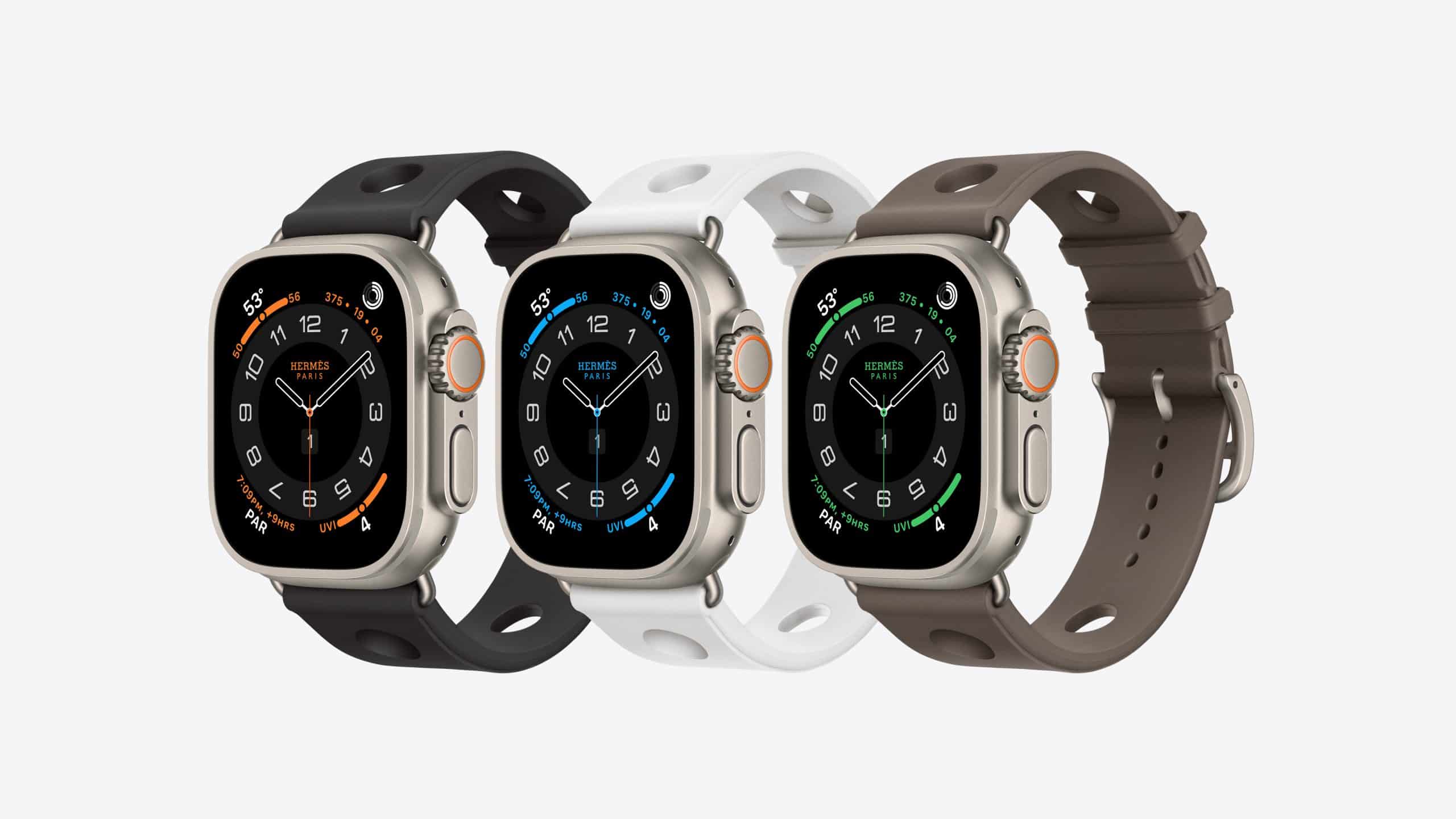 Three smartwatches with black, white, and brown bands are shown side by side. Each features a rectangular display with rounded edges, displaying a dark analog watch face with different accent colors.