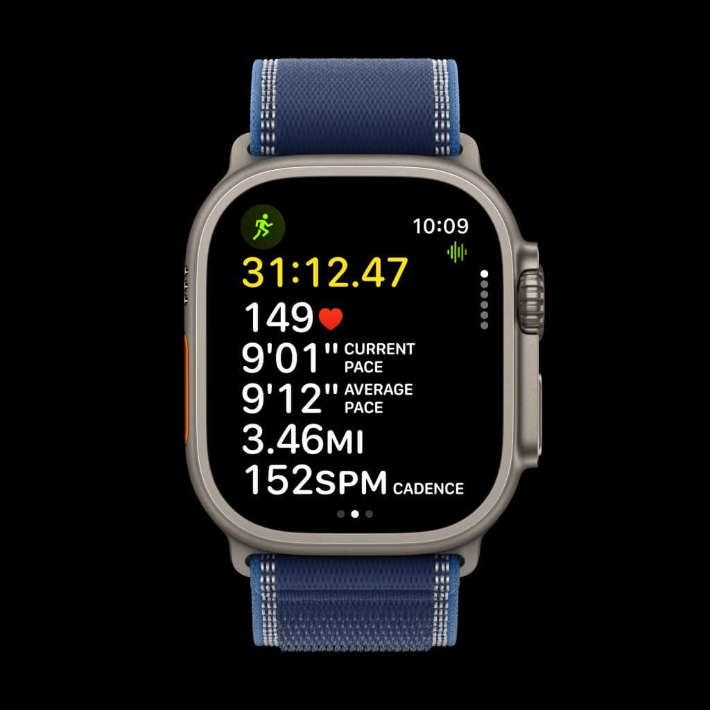A smartwatch displays workout stats: elapsed time 31:12.47, heart rate 149 bpm, current and average pace 9'01" and 9'12" per mile, distance 3.46 miles, and cadence 152 SPM. Blue strap, black background.