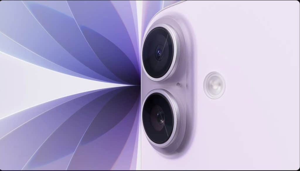 Close-up of a lavender-colored smartphone, resembling the iPhone 17, showing two rear cameras and a flash, set against an abstract purple and white geometric background.