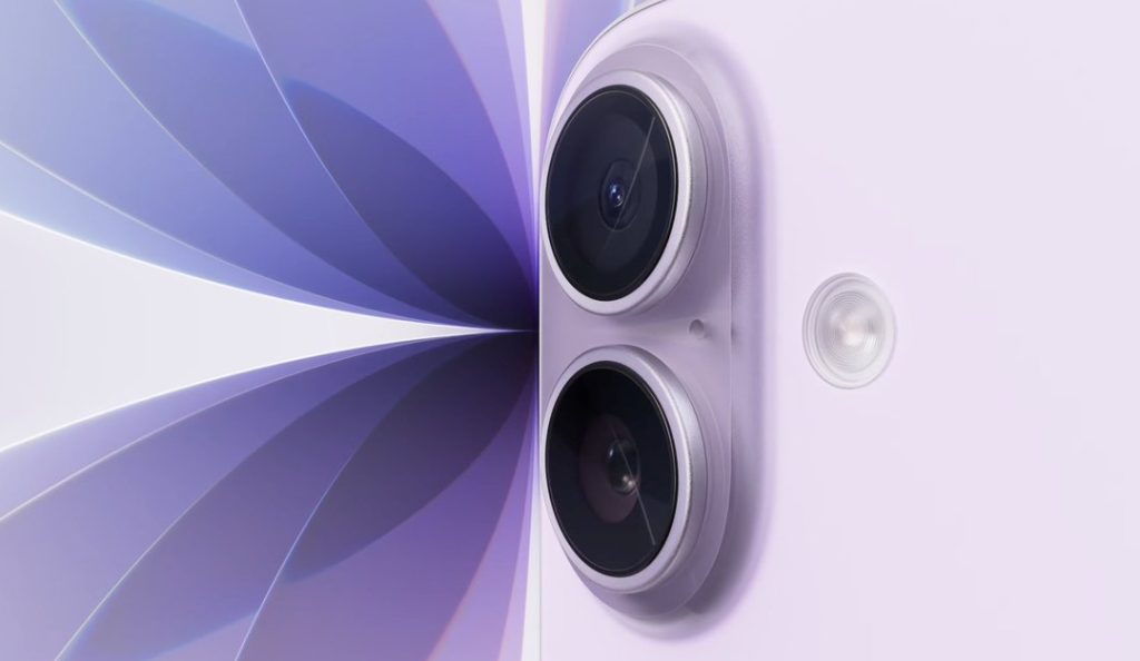 Close-up of a lavender-colored smartphone, resembling the iPhone 17, showing two rear cameras and a flash, set against an abstract purple and white geometric background.