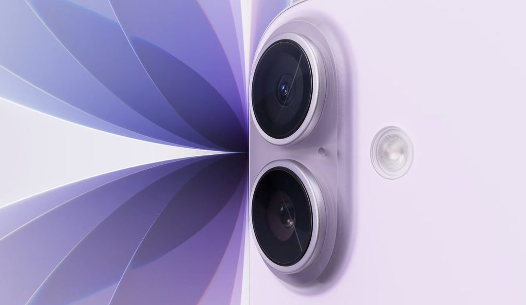 Close-up of a lavender-colored smartphone, resembling the iPhone 17, showing two rear cameras and a flash, set against an abstract purple and white geometric background.