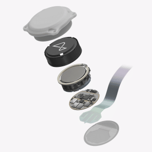 An exploded view of a small electronic device, reminiscent of a Neuralink brain implant, showing its outer shell, battery, circular sensor, circuit board, and connecting ribbon cable, all aligned vertically against a white background.