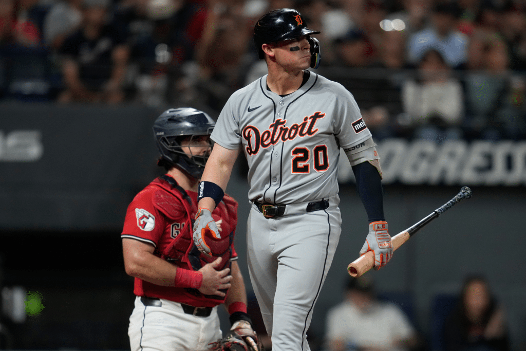 A Detroit Tigers player stands at home plate holding a bat, glancing to the side, as the Red Sox catcher in red gear waits behind him during a Red Sox vs Tigers game—captured perfectly on an iPhone 17 Pro.