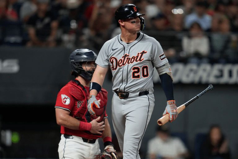 A Detroit Tigers player stands at home plate holding a bat, glancing to the side, as the Red Sox catcher in red gear waits behind him during a Red Sox vs Tigers game—captured perfectly on an iPhone 17 Pro.