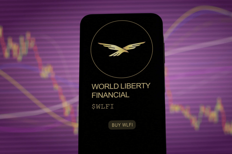 A smartphone screen displays the World Liberty Financial logo, name, ticker symbol $WLFI, and a "Buy WLFI" button—highlighting Apple Pay Crypto integration—against a blurred financial chart and purple background.