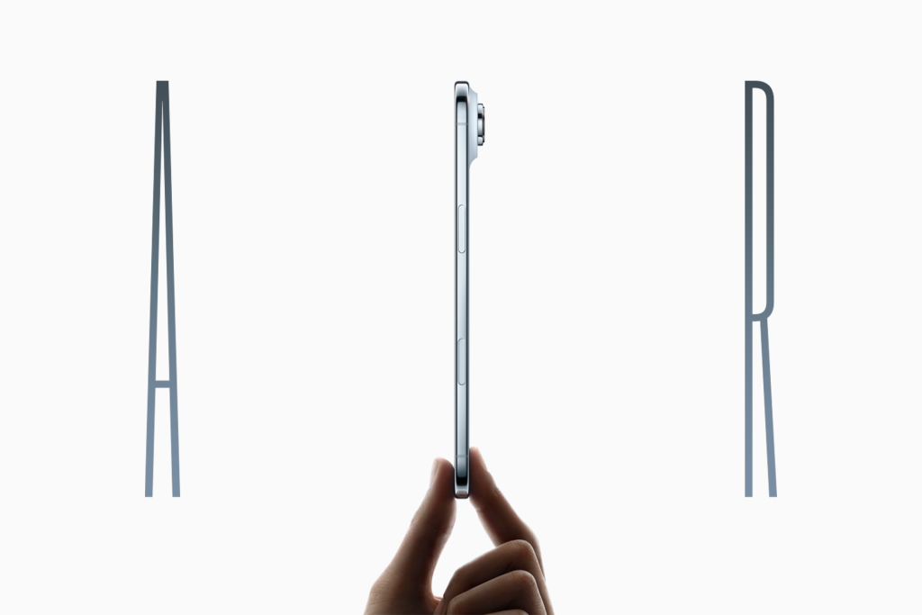 A hand holds a slim iPhone Air vertically against a white background. Large, thin letters "A" on the left and "R" on the right frame the phone, highlighting its thin profile and key differences from previous models.