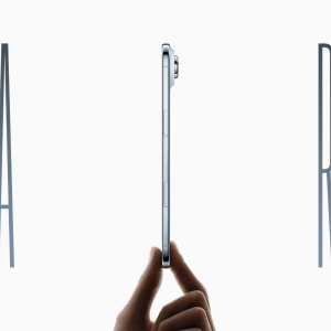 A hand holds a slim iPhone Air vertically against a white background. Large, thin letters "A" on the left and "R" on the right frame the phone, highlighting its thin profile and key differences from previous models.