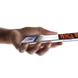A hand holds a Super-Thin iPhone Air horizontally, displaying a digital wallet app with a credit card and event ticket visible on the sleek metallic-edged screen.