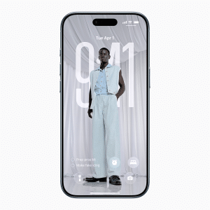 A Super-Thin iPhone Air displays its lock screen with a large clock reading 9:41 and the date Tue, Apr 1. The background shows a person in a light blue outfit and black shoes standing before draped white fabric.