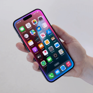 A hand holding a modern smartphone displaying a colorful home screen with various app icons, including the Apple Veritas AI chatbot, on a light, blurred background.