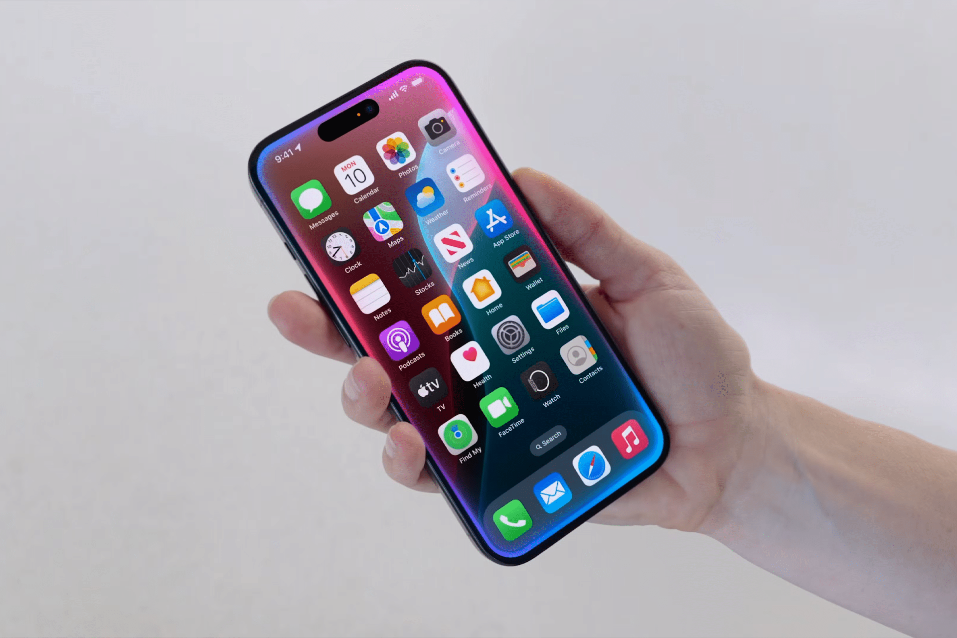 A hand holding a modern smartphone displaying a colorful home screen with various app icons, including the Apple Veritas AI chatbot, on a light, blurred background.