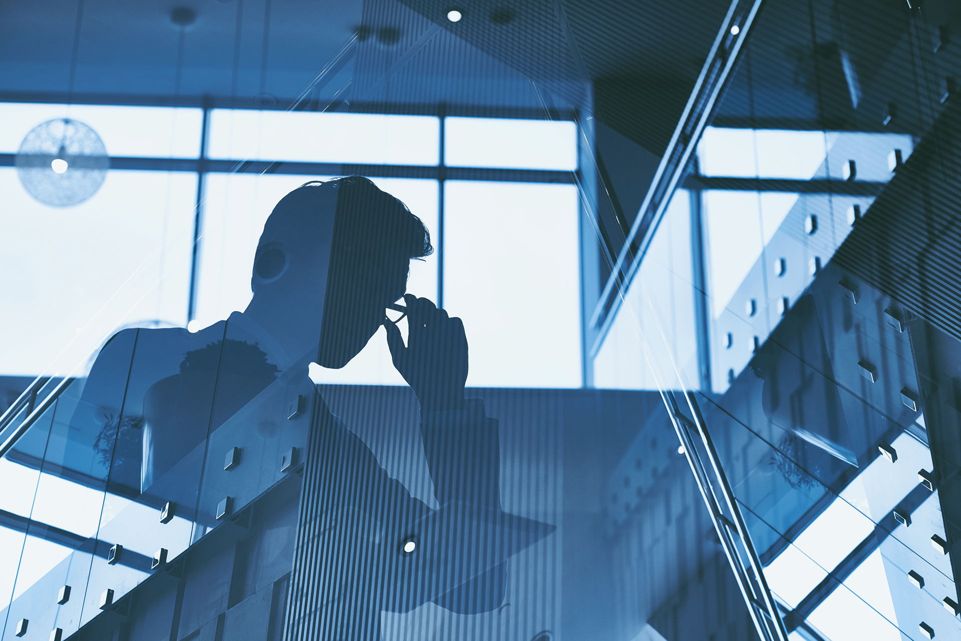 A double exposure image of a man adjusting his glasses, overlaid with a modern office stairwell and large windows, creating a blue-tinted abstract business scene where ChatGPT rivals human experts.