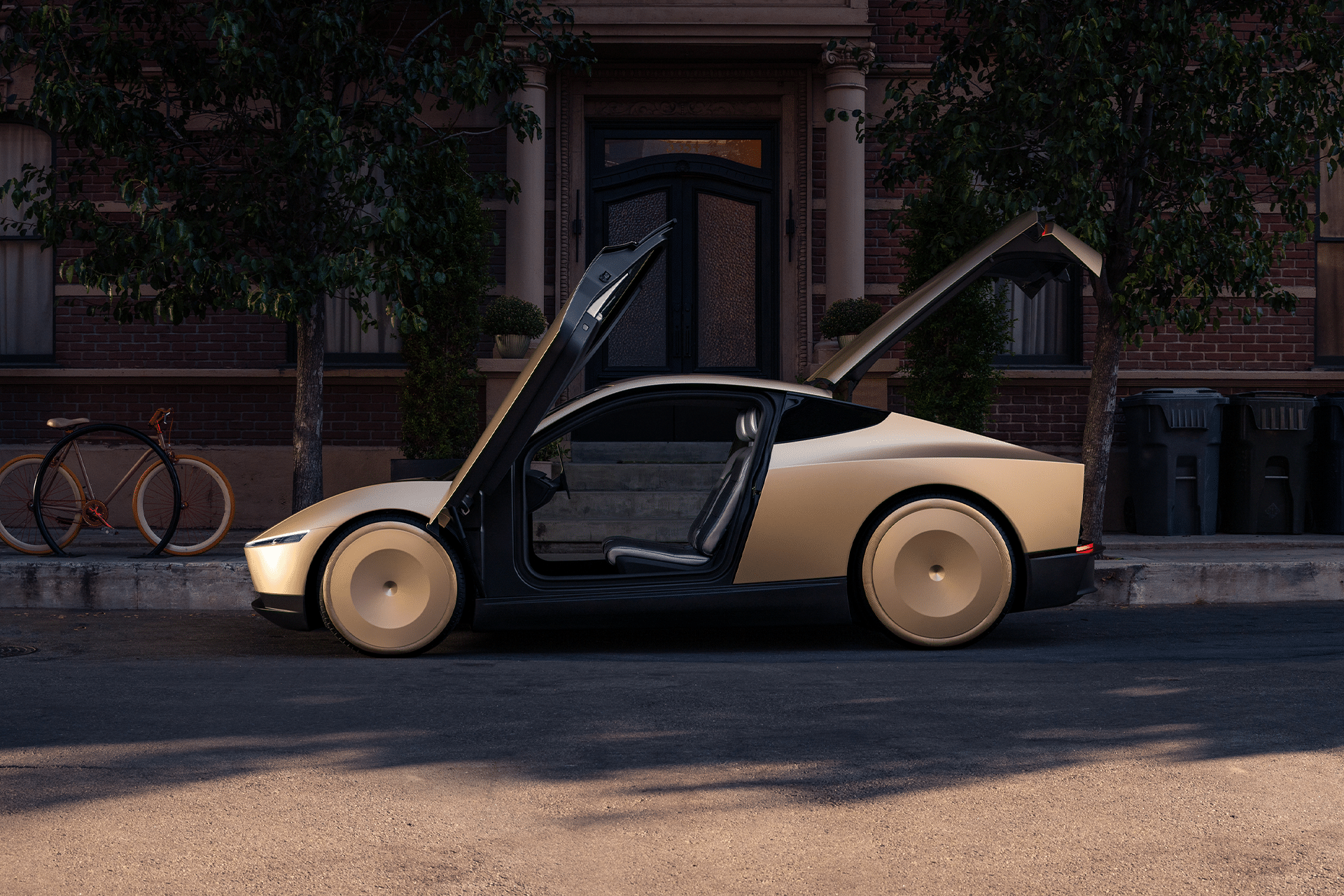 A futuristic gold car with gull-wing doors open—reminiscent of Elon Musk's robotaxi production—parks on a city street in front of a brick building. A bicycle leans against a tree on the nearby sidewalk.