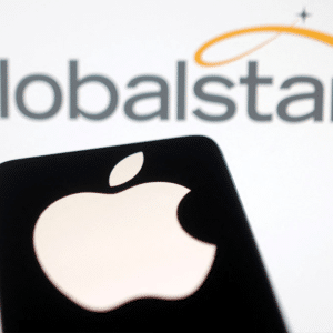A silhouette of an Apple logo is held up in front of a screen displaying the Globalstar logo with stylized stars and an orange swoosh, referencing the recent Globalstar SpaceX acquisition.