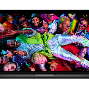 A 14-inch MacBook Pro with the new M5 chip displays a vibrant image of a lively group of people in colorful, shiny outfits, cheering and celebrating in a festive atmosphere.