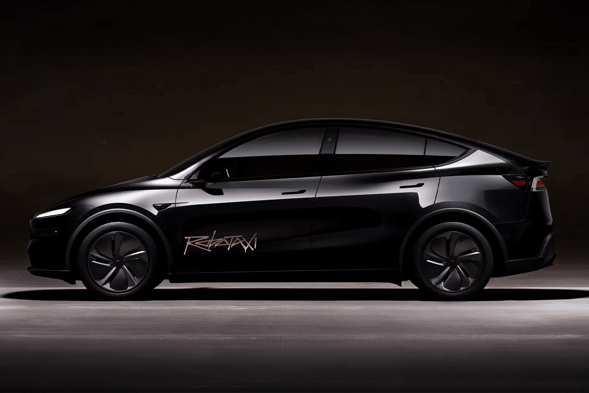 A sleek black electric SUV with tinted windows and a bold gold "REKTAN" logo on the driver’s door, parked in a dimly lit space—evoking the futuristic vibe of a Waymo vs Tesla robotaxi showdown.