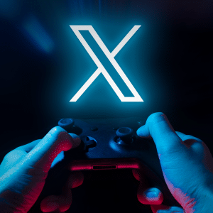 A person’s hands holding a game controller with a large glowing X logo in the center, hinting at an xAI AI-powered video game, set against a dark background with a subtle Apple logo in the corner.