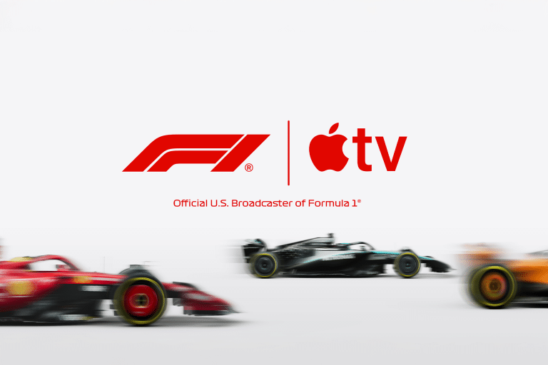 Three blurred Formula 1 cars race across the bottom of the image. Above them, the F1 and Apple TV logos appear with the text “Official U.S. Broadcaster of Formula 1,” highlighting the Apple Formula 1 broadcast partnership.