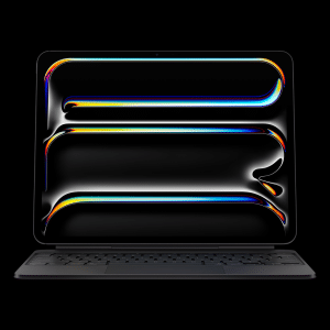 A sleek, black laptop with a keyboard attached displays a dark screen featuring colorful, fluid, neon-like lines—reminiscent of an iPad Pro M5 chip’s vibrant visuals—forming rectangular and oval shapes against a black background.