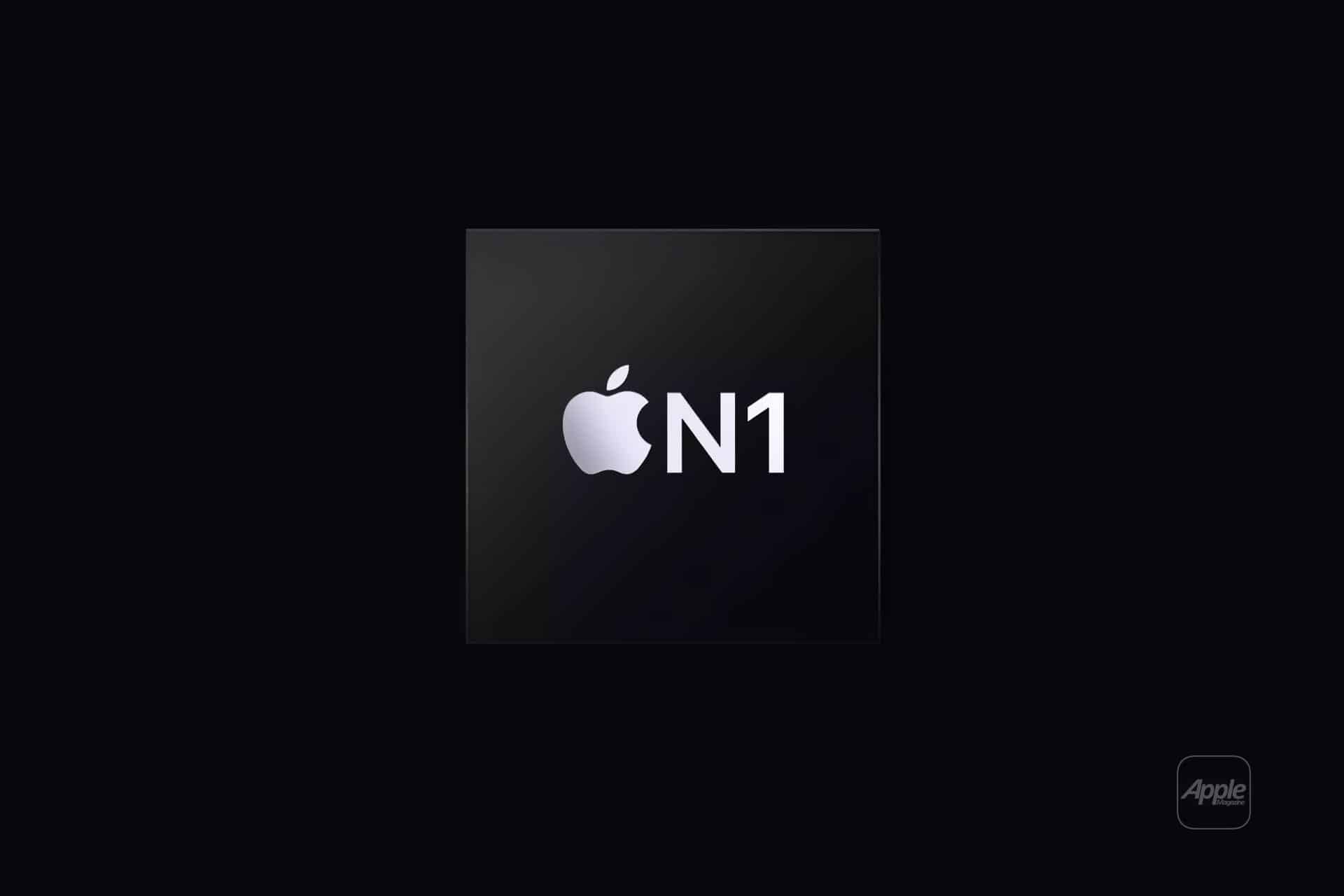 A dark square chip with the white Apple logo and "N1" text in the center, set against a black background. This is the Apple N1 Wireless Processor, with a faint Apple logo also appearing in the lower right corner.