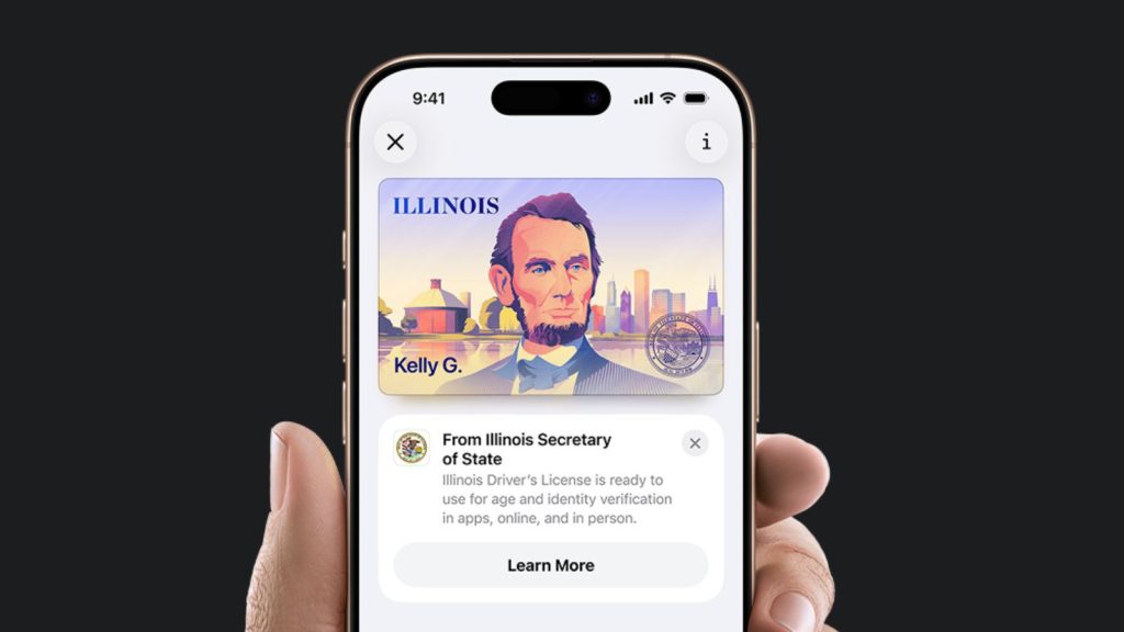 A hand holds a smartphone displaying an Illinois Digital ID in Apple Wallet, featuring Abraham Lincoln's portrait and the name "Kelly G." The screen also shows a notification about Illinois driver's license ID verification.