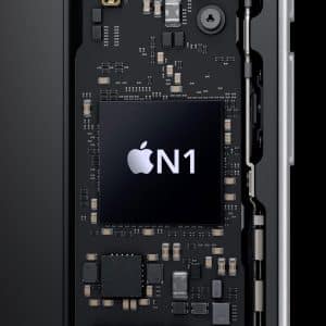 Close-up of a circuit board inside an electronic device, featuring a large black chip labeled with the Apple logo and "N1" in white text—identifying it as the Apple N1 wireless processor. Various electronic components surround the central chip.