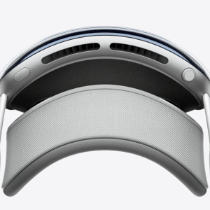 Close-up view of a modern virtual reality headset from above, featuring a curved headband, cushioned padding, ventilation slots, and adjustable side supports—perfectly suited for Apple immersive video production with its sleek, minimalist white and gray design.