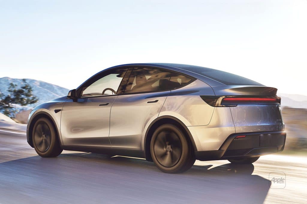 A sleek silver electric car with tinted windows and Musk-inspired aerodynamic design drives on a sunlit road, mountains and clear skies behind it—its thin horizontal taillights hinting at data-driven innovation.