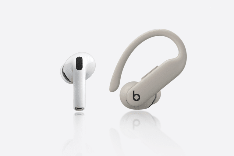 A white wireless earbud and a beige over-ear hook earbud with a "b" logo are displayed side by side, highlighting the design differences between AirPods Pro 3 vs Powerbeats Pro 2 on a clean white background.