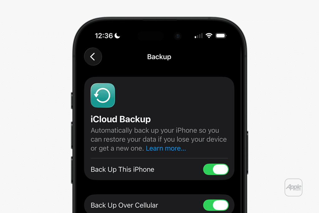 A smartphone screen displays the iCloud Backup settings, both options toggled on. Perfect for an iPhone backup guide, it shows how to back up your iPhone and use cellular data. The time is 12:36, and the device is charging.