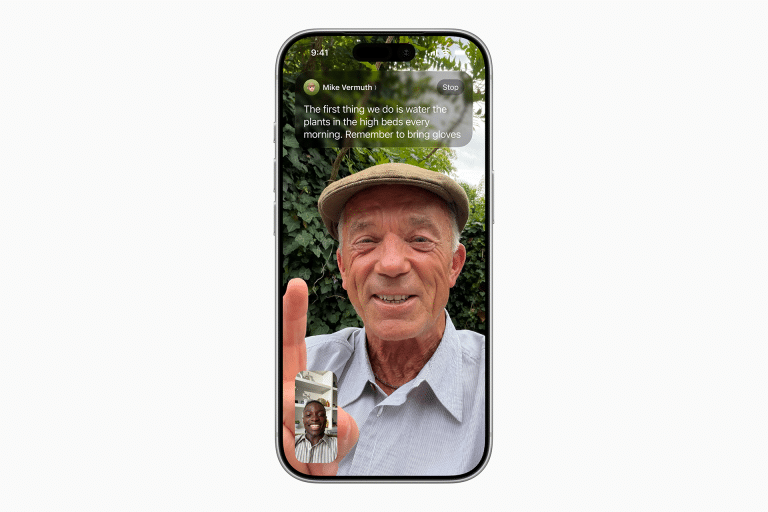 A smiling older man in a flat cap is on a Facetime video call, holding up his index finger. He is outside with greenery behind him. A small inset shows another smiling man on the call. Text instructions appear at the top of the screen.