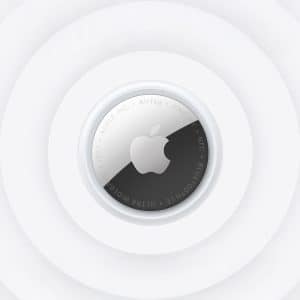 A close-up view of the new AirTag placed at the center of concentric white circles, highlighting the device's metallic surface and engraved Apple logo.
